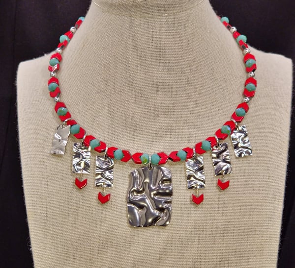 This choker features A Textured Stainless Steel Pendant and Sterling Plated Brass links