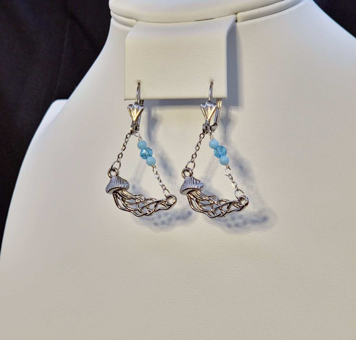 Stainless Steel earrings with a stainless steel silver jellyfish charm hanging on a stainless steel chain