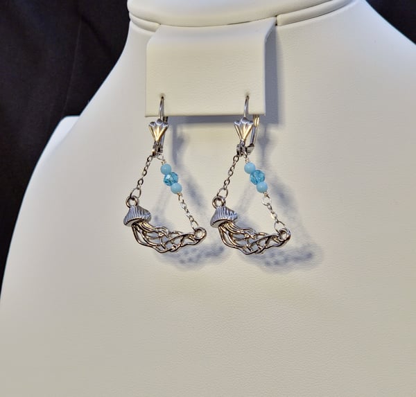 Stainless Steel earrings with a stainless steel silver jellyfish charm hanging on a stainless steel chain