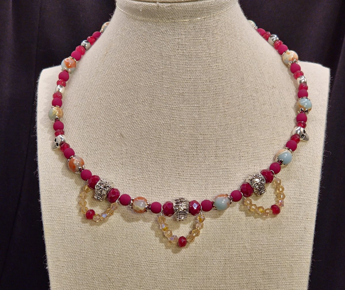 A Choker featuring silver skull beads, frosted dark coral glass beads and crystal faceted bicone beads