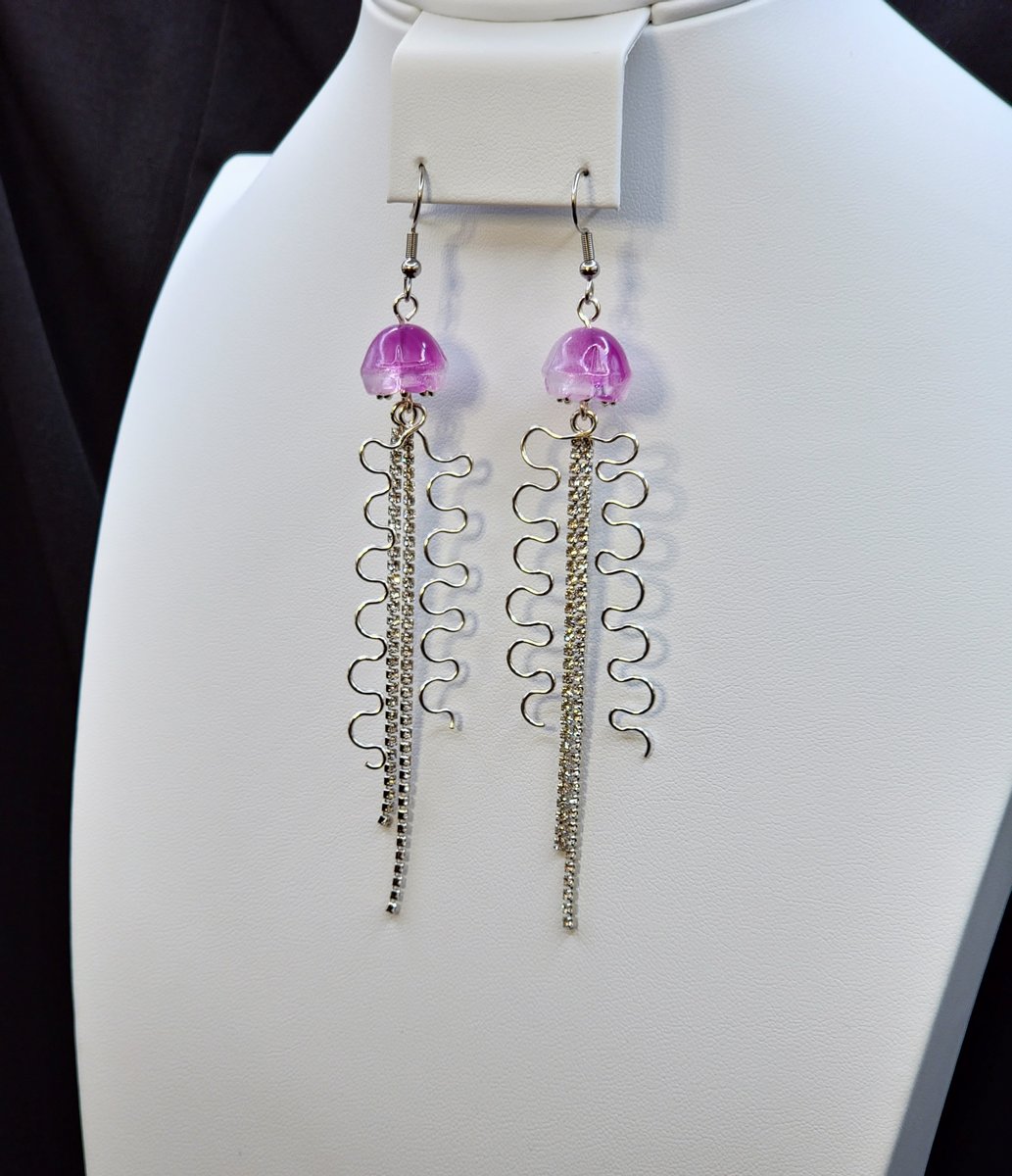 A Rhinestone dangle with a glass Jellyfish bead and hammered silver plated wire