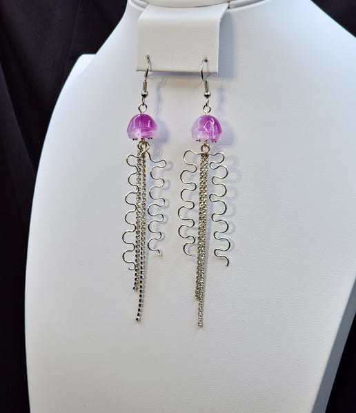 A Rhinestone dangle with a glass Jellyfish bead and hammered silver plated wire